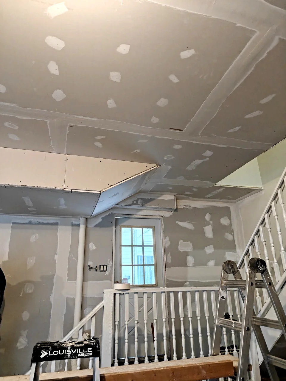 New plastered drywall on walls and ceiling